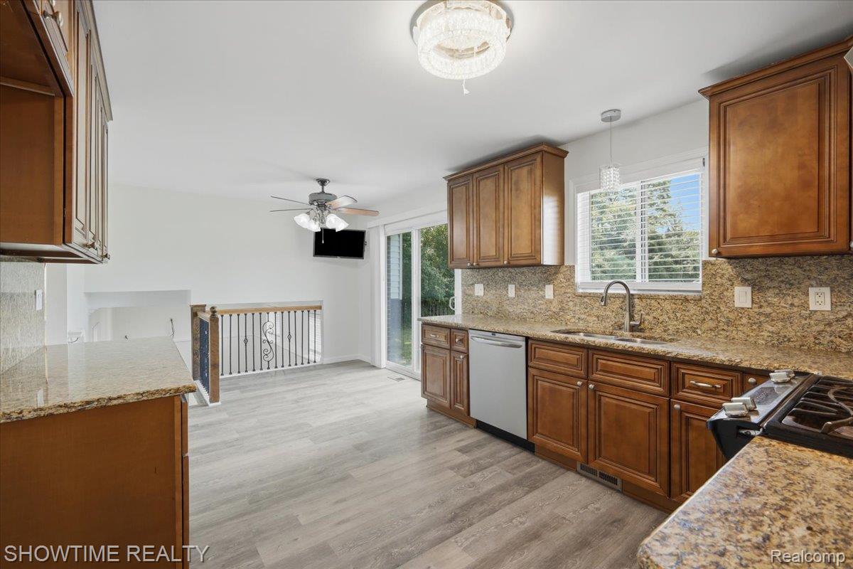29255 Utley Road Farmington, MI 48334 - Photo 17 of 46 Wood-finish flooring, recessed lighting, built-in cabinetry, and a ceiling fan with integrated light