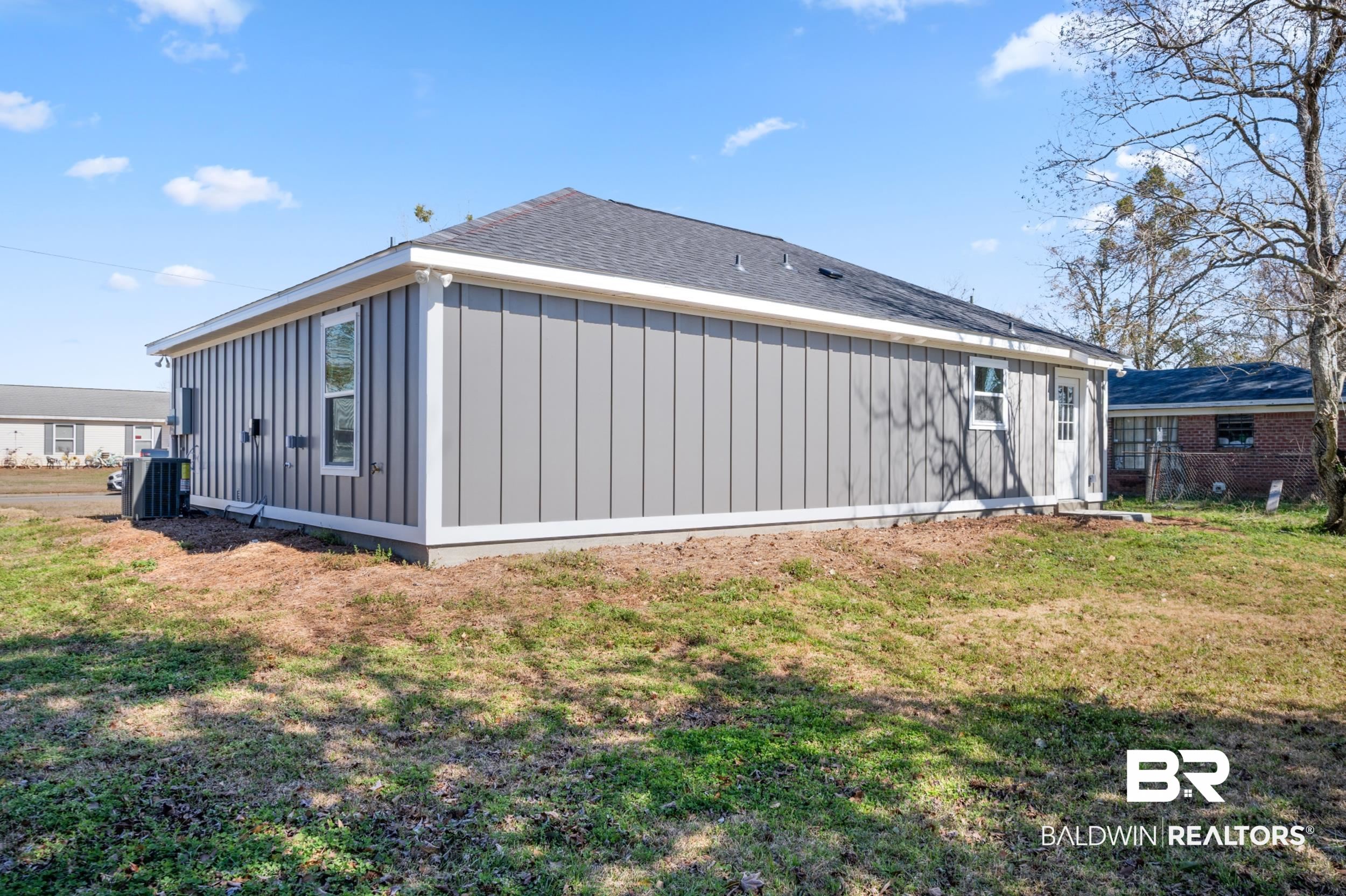 76 Fincher Lane Loxley, AL 36551 - Photo 28 of 33 Rear view of property featuring board and batten siding and roof with shingles