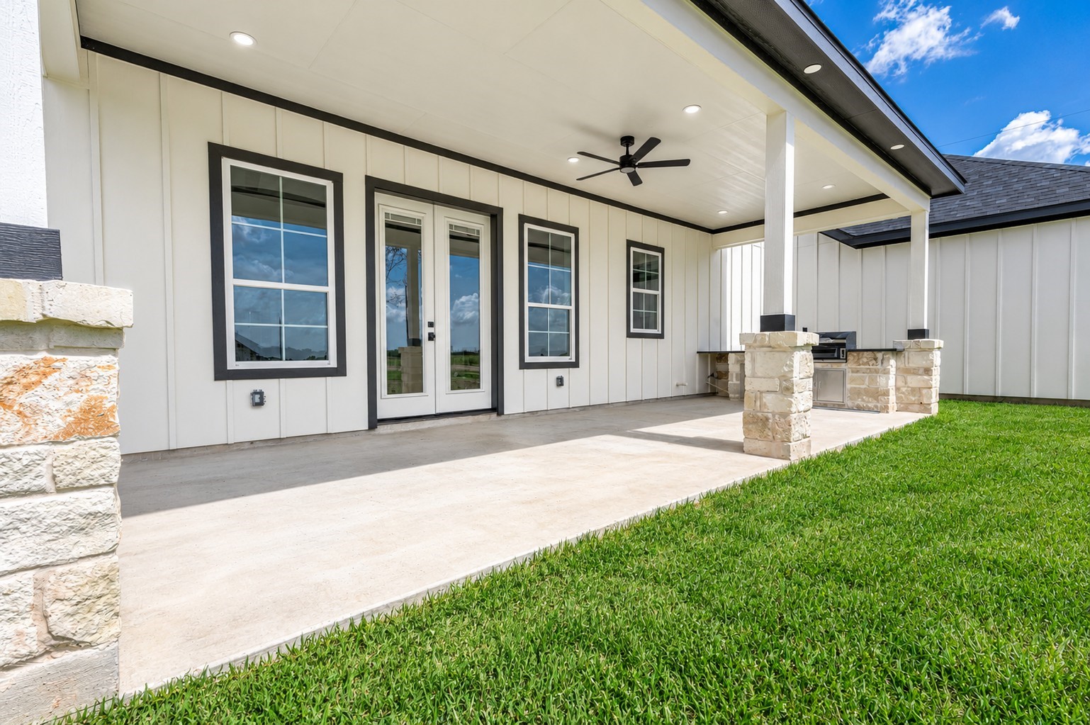 13911 Routt Point Road Needville, TX 77461 - Photo 13 of 19 Covered back patio featuring an outdoor kitchen, ceiling fan, and plenty of space for relaxing or entertaining.
