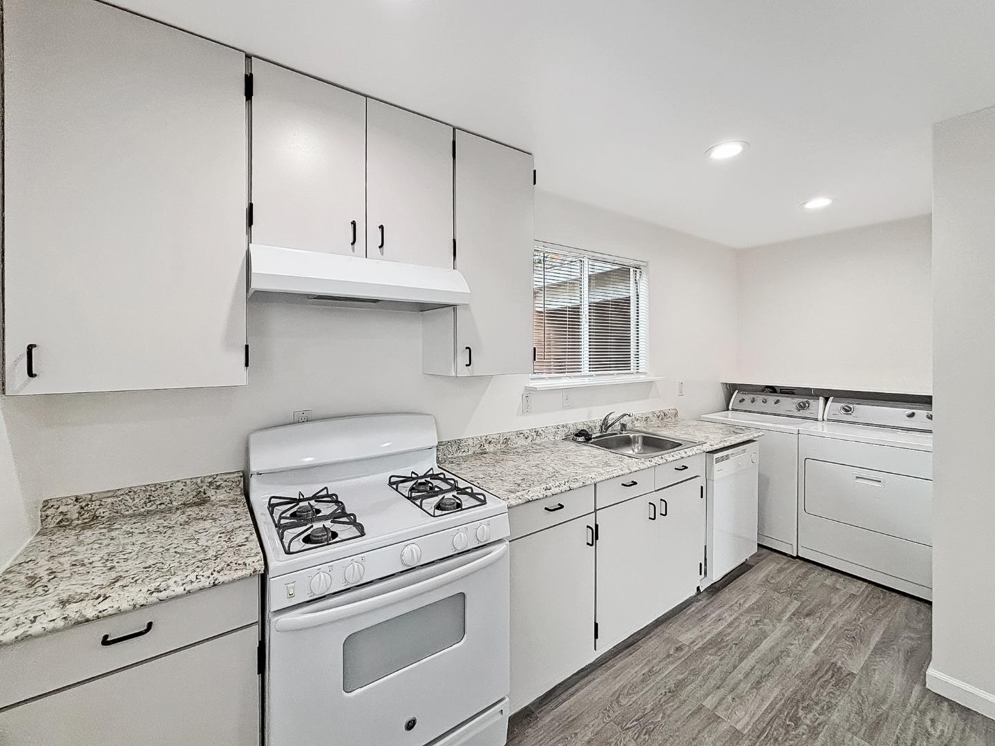 25583 Spring Drive Hayward, CA 94542 - Photo 14 of 27 a kitchen with white cabinets and white appliances