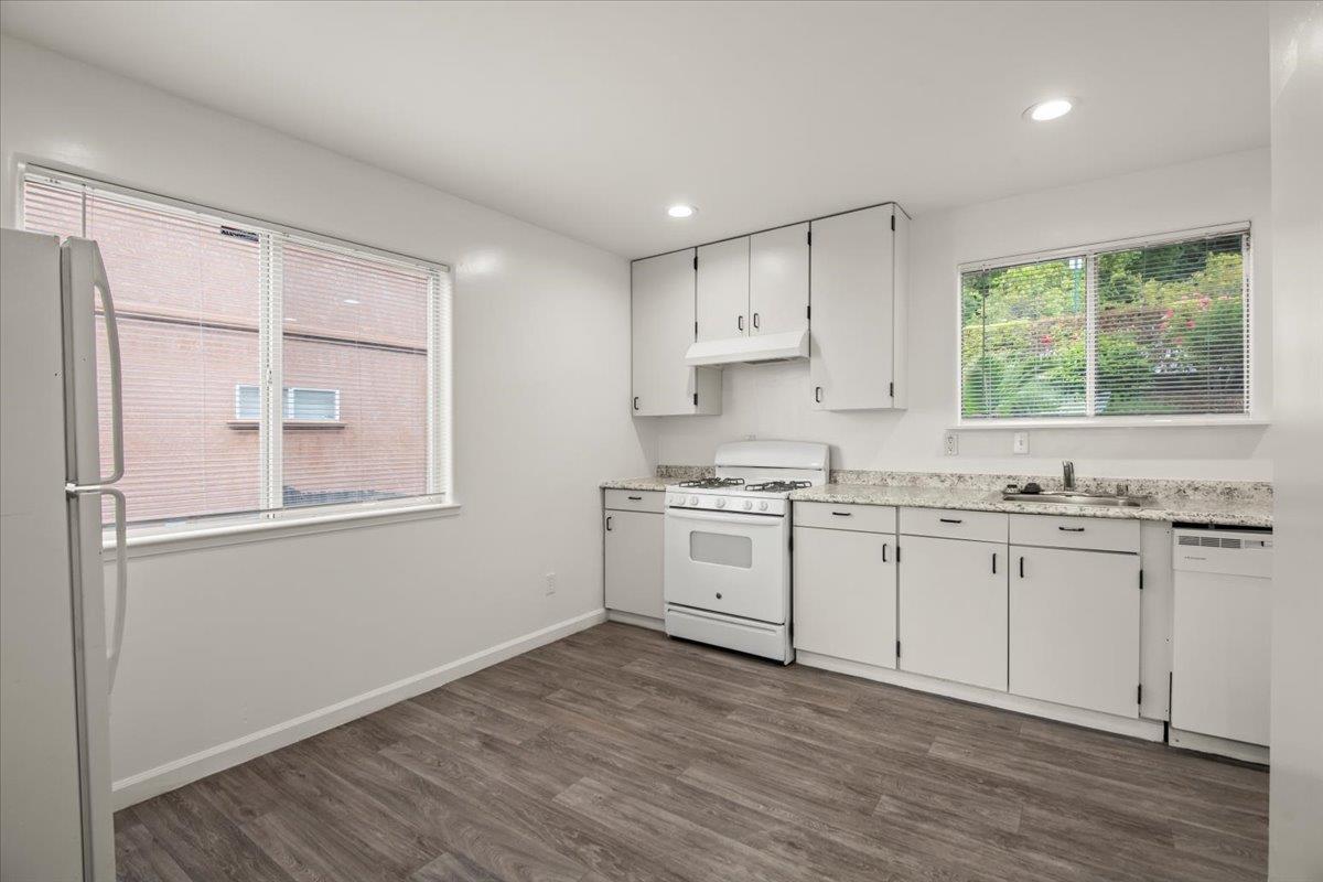 25583 Spring Drive Hayward, CA 94542 - Photo 16 of 27 a kitchen with granite countertop white cabinets and white appliances