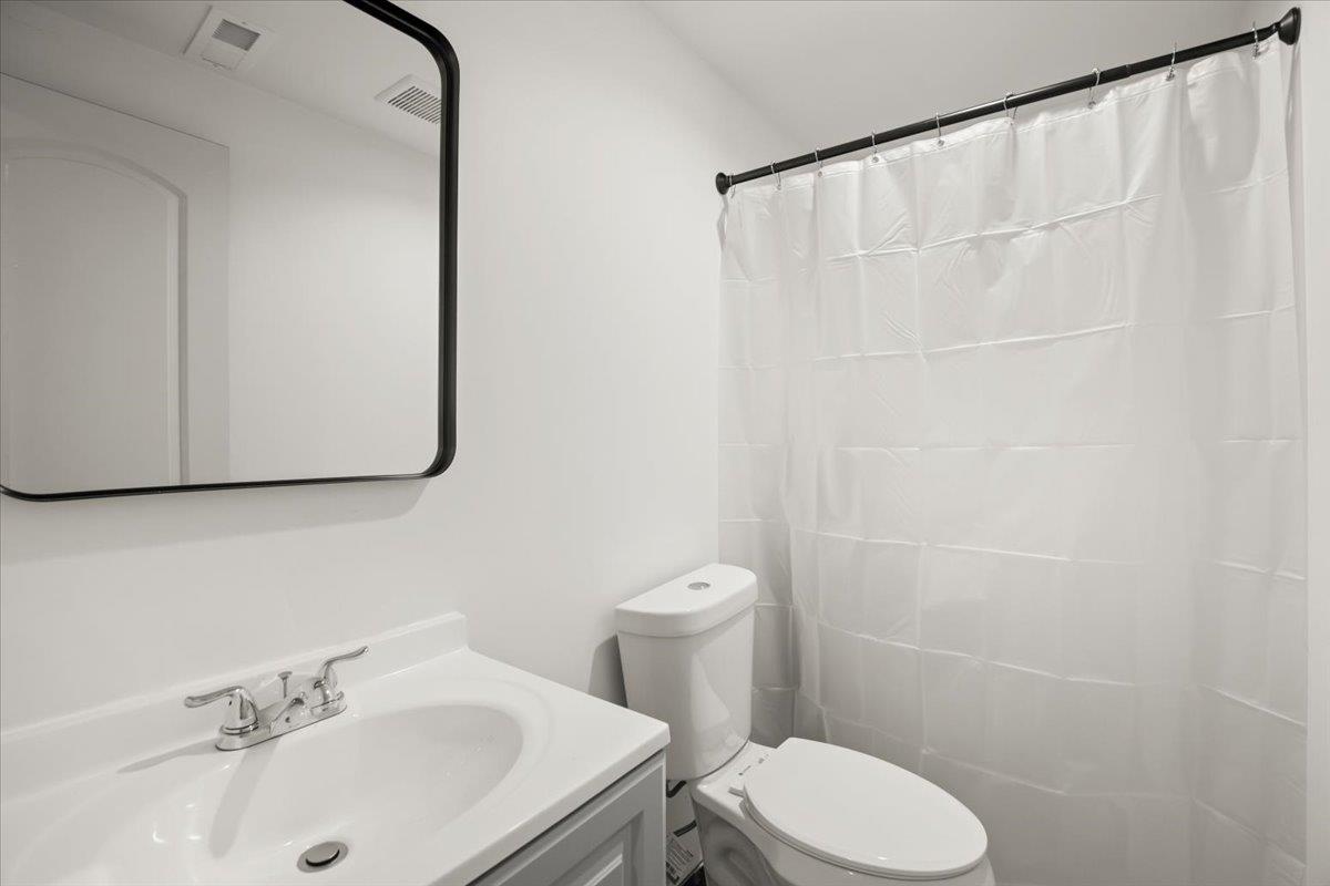 25583 Spring Drive Hayward, CA 94542 - Photo 20 of 27 a bathroom with a sink a toilet and a mirror