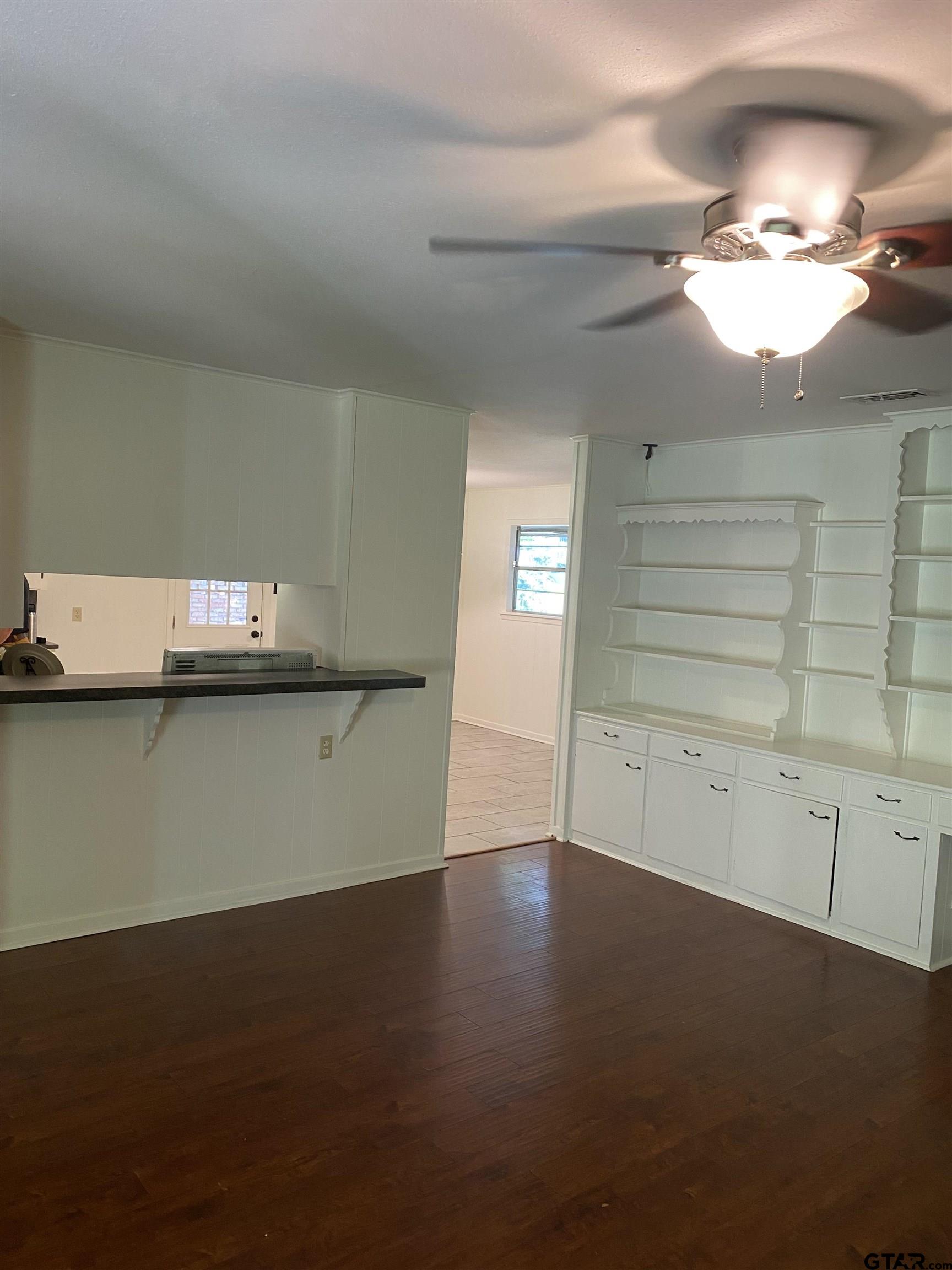 2613 Chelsea Drive Tyler, TX 75701 - Photo 14 of 33 a view of a room with wooden floor and a ceiling fan