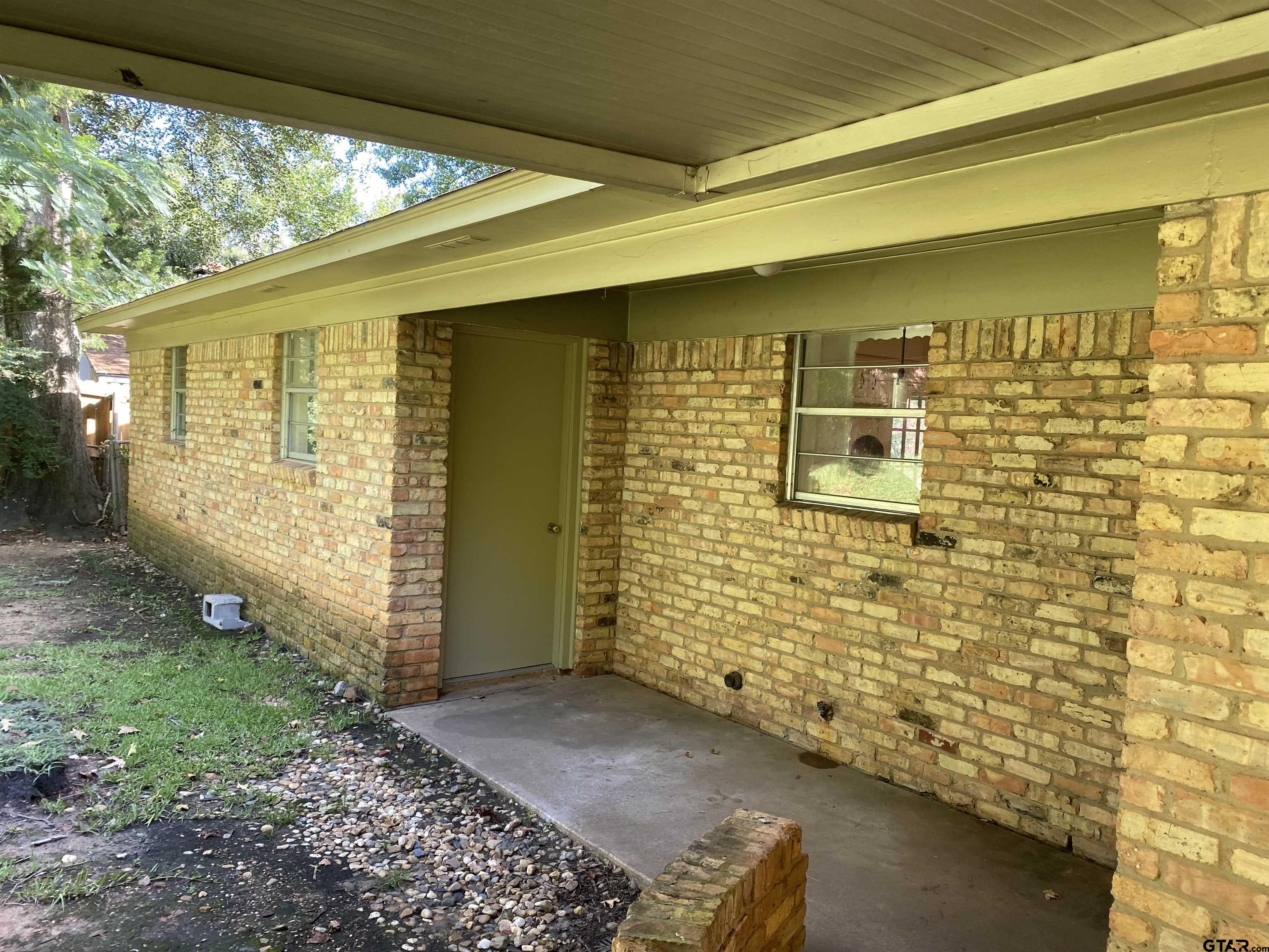 2613 Chelsea Drive Tyler, TX 75701 - Photo 16 of 33 a view of front door of house with a yard