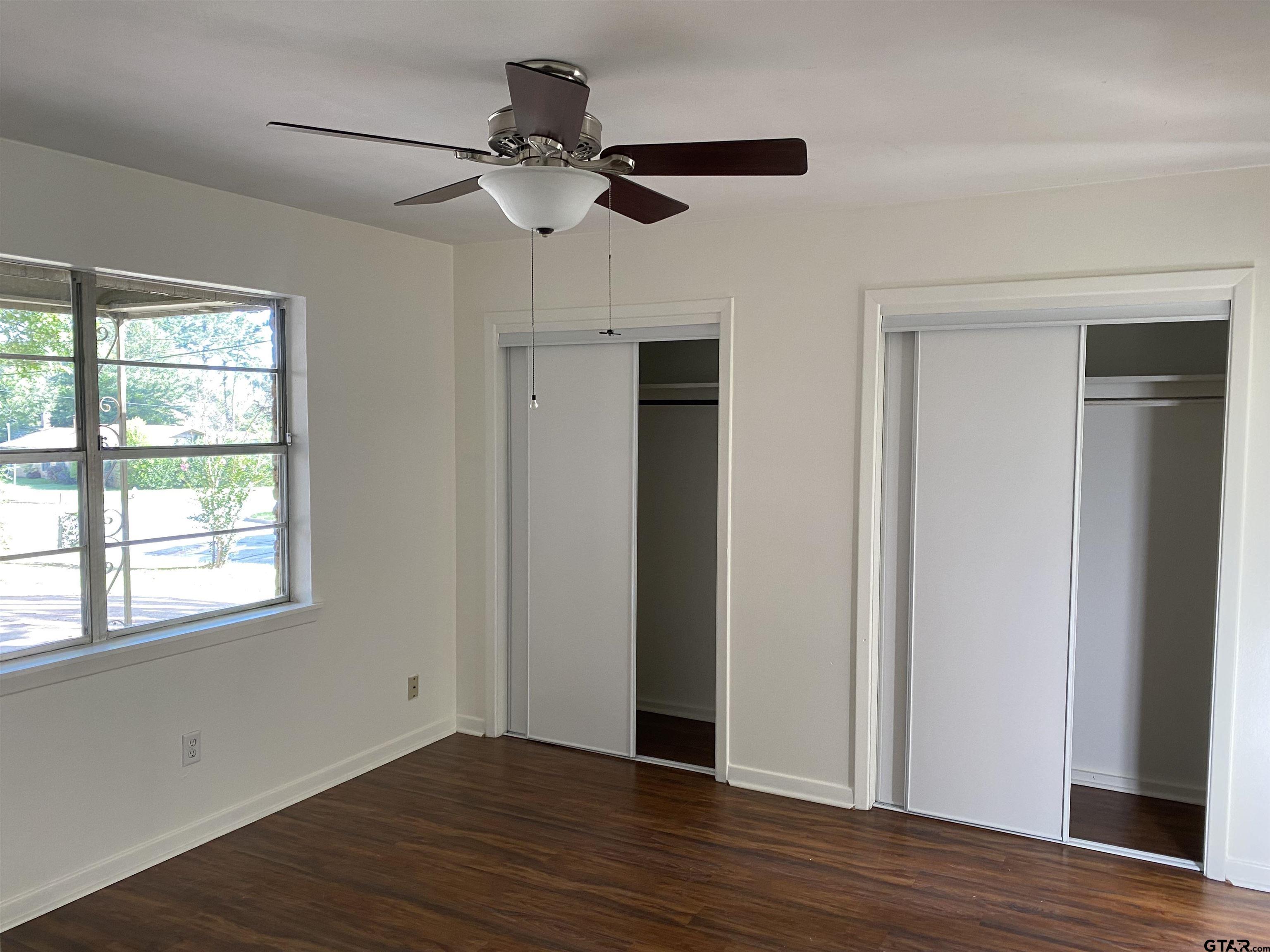 2613 Chelsea Drive Tyler, TX 75701 - Photo 21 of 33 a view of an empty room with wooden floor and a window