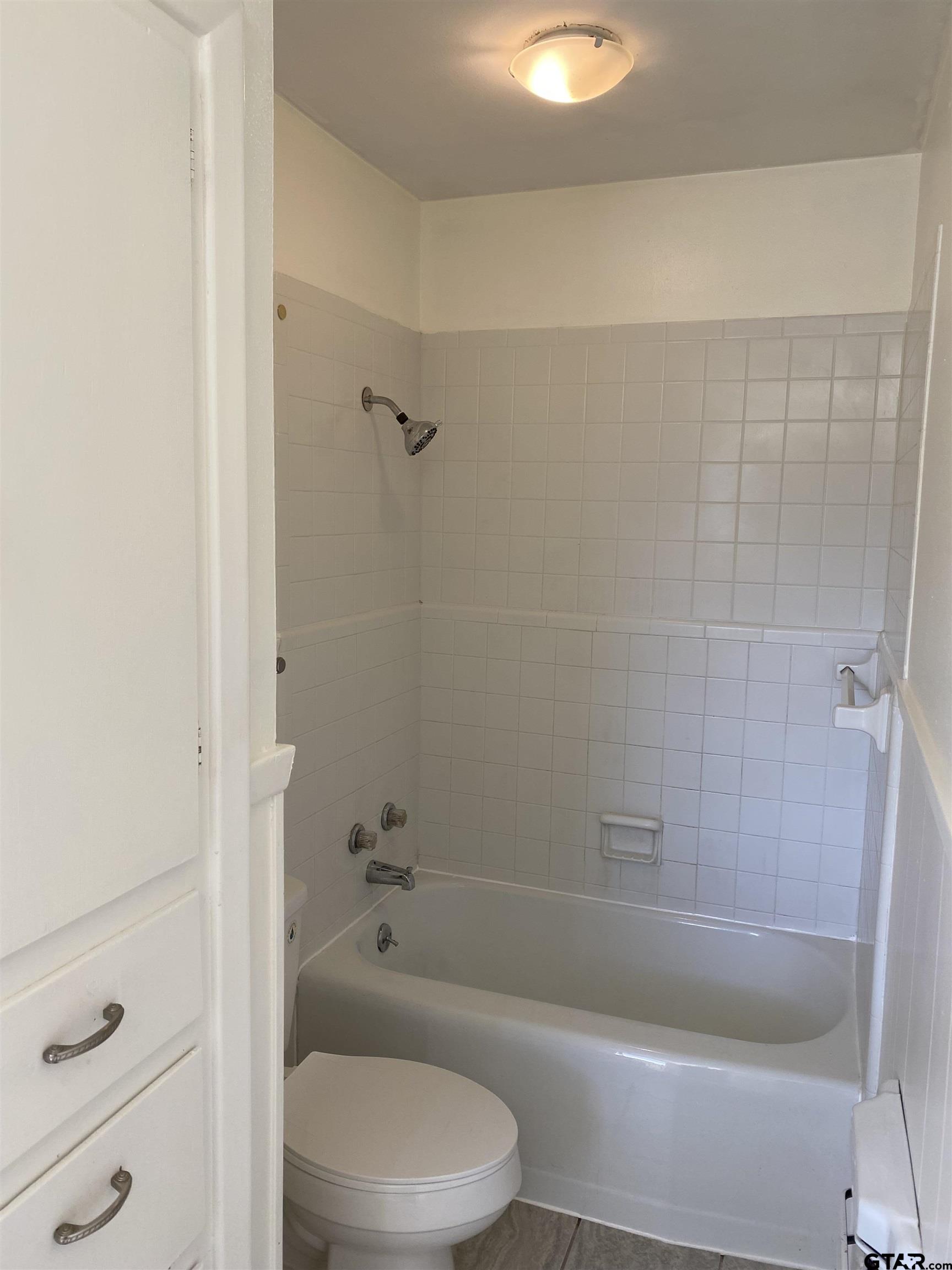 2613 Chelsea Drive Tyler, TX 75701 - Photo 23 of 33 a bathroom with a bathtub and a toilet