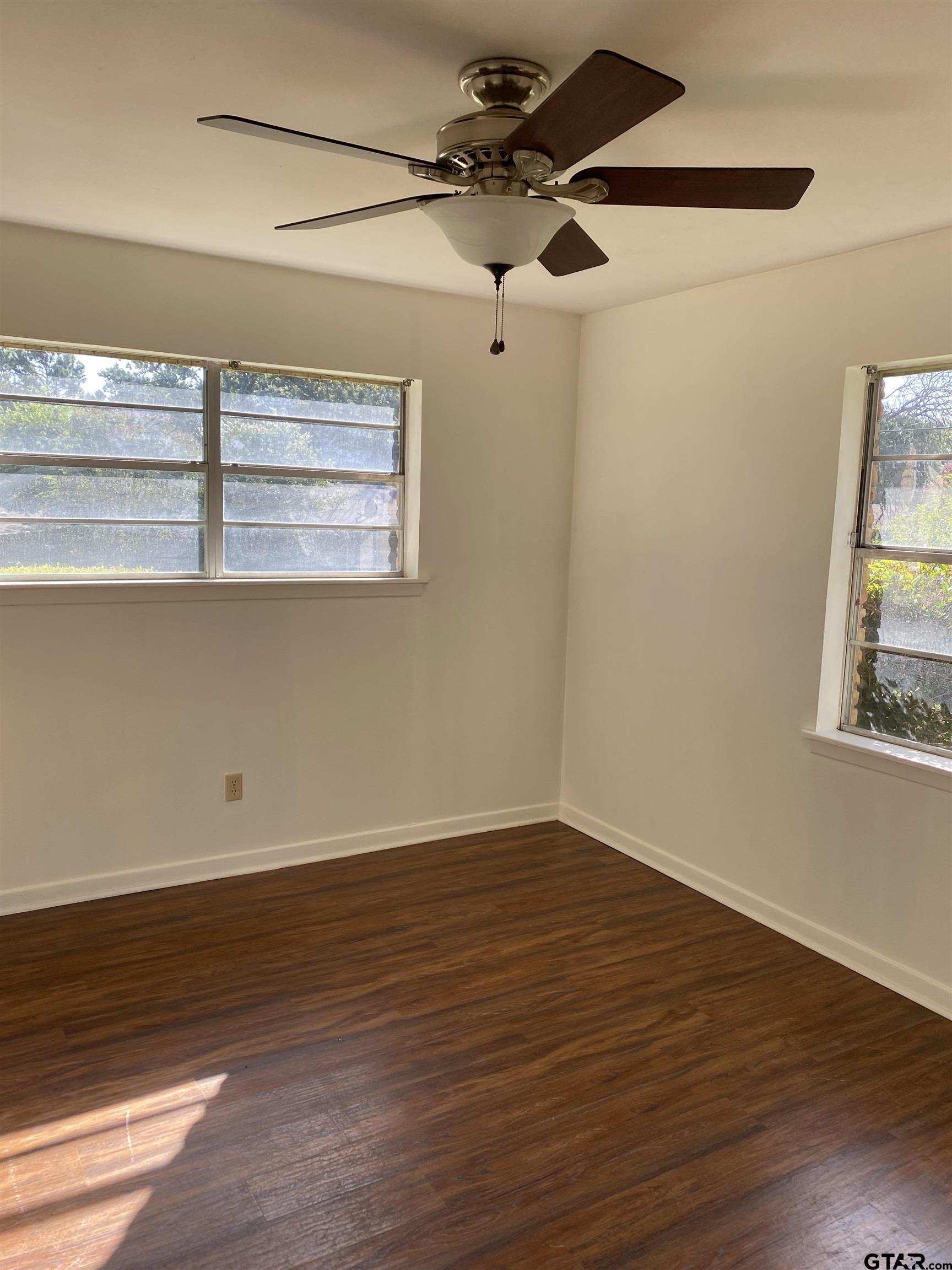2613 Chelsea Drive Tyler, TX 75701 - Photo 27 of 33 a view of an empty room with wooden floor and a window