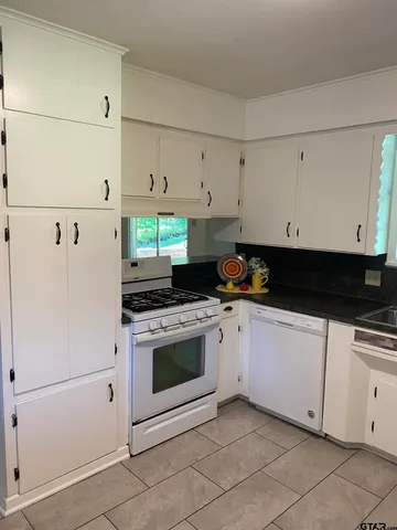 a dining room with a window and chandelier