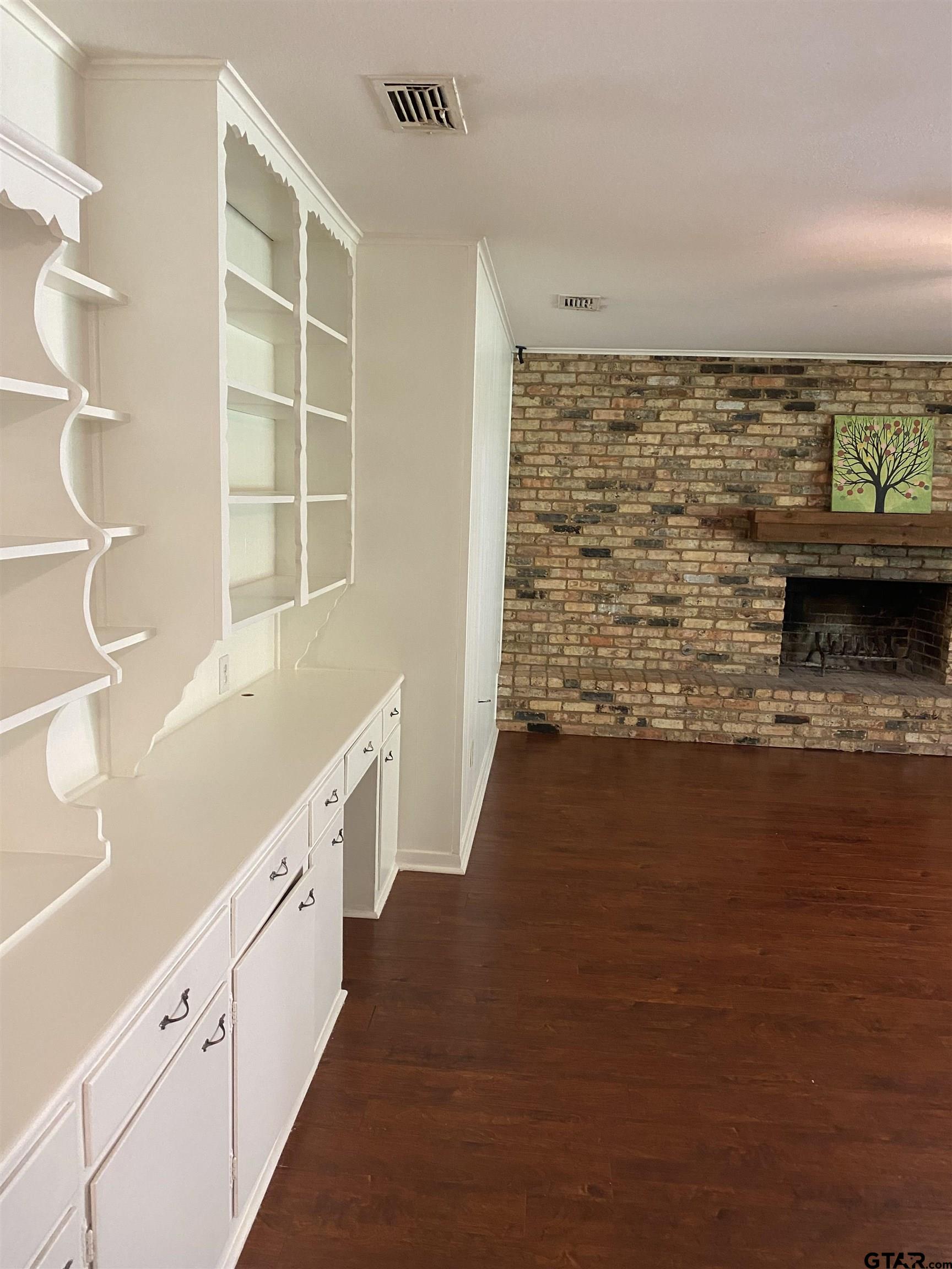 2613 Chelsea Drive Tyler, TX 75701 - Photo 32 of 33 a view of open kitchen with wooden floor and cabinets