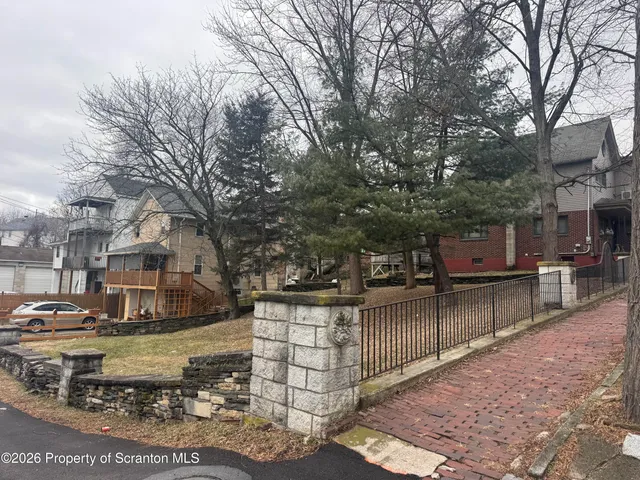 a view of city street with wooden fence