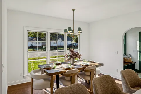 a view of a dining room with furniture window and wooden floor