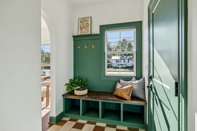 a living room with furniture and a potted plant