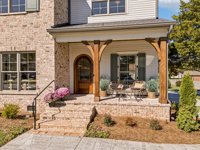 a front view of a house with outdoor seating