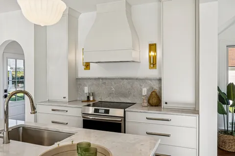 a kitchen with a white cabinets and appliances
