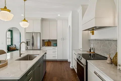 a kitchen that has a sink and a stove