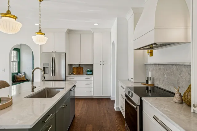 a kitchen that has a sink and a stove