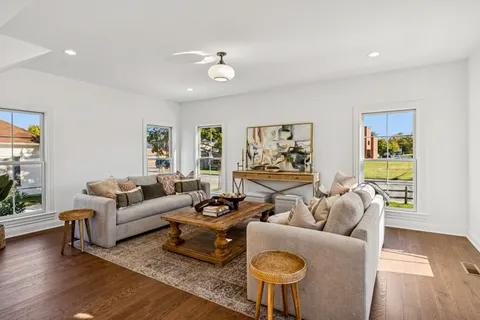 a living room with furniture and wooden floor