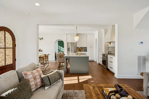 a living room with furniture window and wooden floor