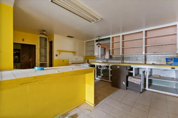 a open kitchen with a sink and cabinets