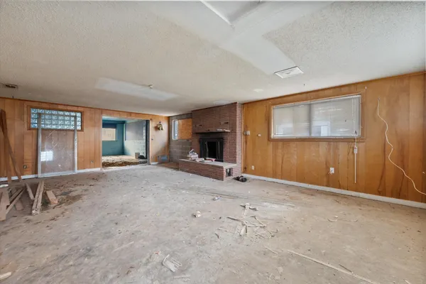 an empty room with furniture and windows