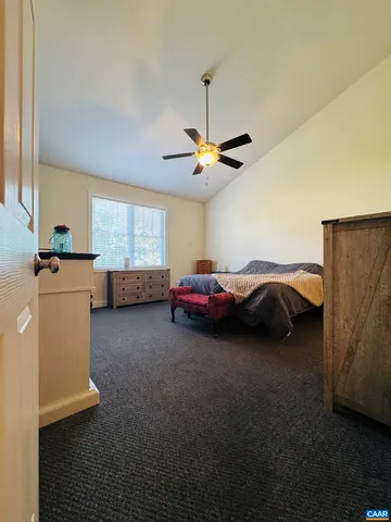 a view of a hallway with wooden floor and furniture