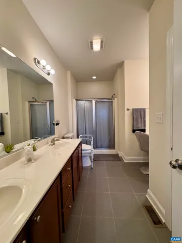 a room with furniture and a air conditioner vent