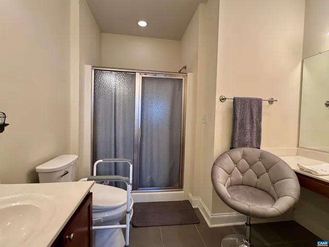 a view of a room with a mirror and wooden floor