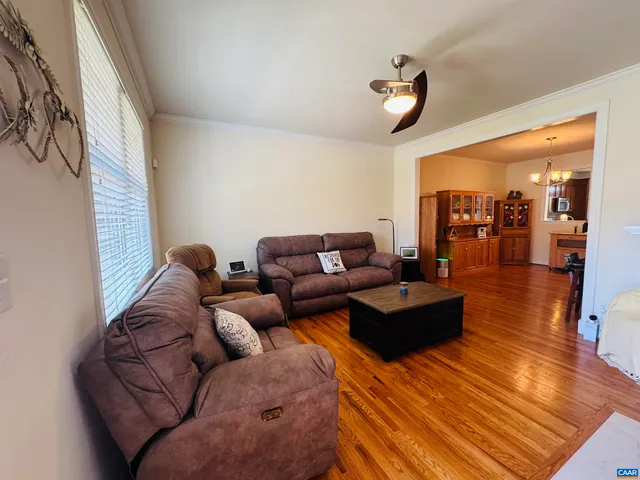 a view of a dining room with furniture and chandelier