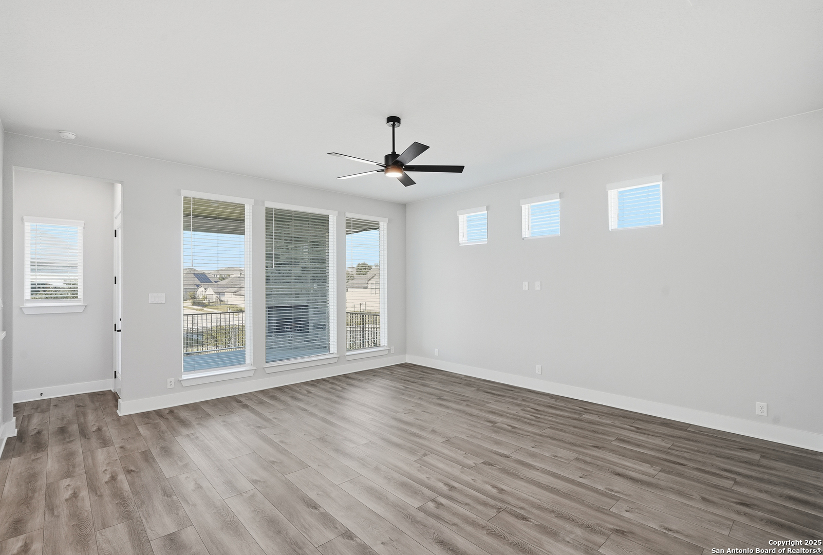 326 Vamanos Boerne, TX 78006 - Photo 13 of 55 a view of an empty room with wooden floor and a window
