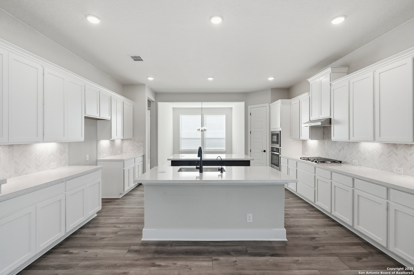 326 Vamanos Boerne, TX 78006 - Photo 17 of 55 a large kitchen with stainless steel appliances kitchen island granite countertop a stove a sink and white cabinets