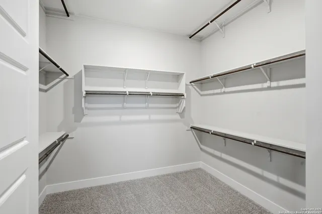 a view of a kitchen with wooden floor and electronic appliances