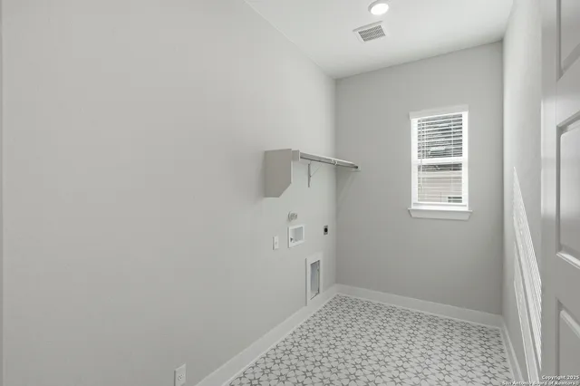 an empty room with fan and windows