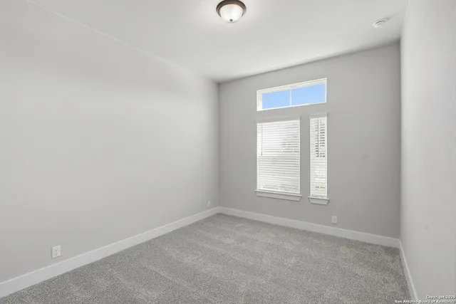 a view of an empty room with closet area