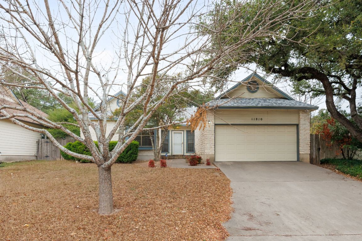 View of front of property with driveway and a garage