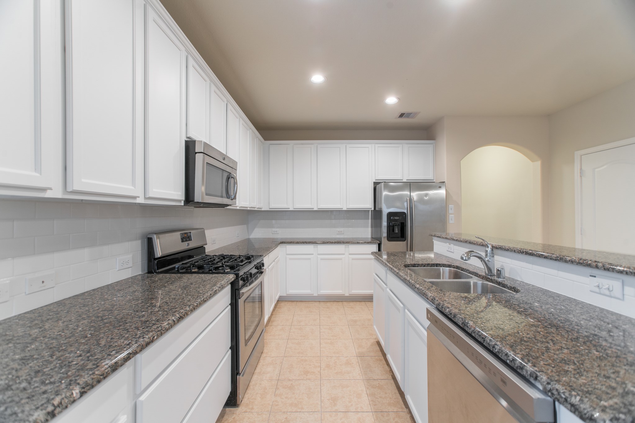 78 East Heritage Mill Circle The Woodlands, TX 77375 - Photo 13 of 50 a kitchen with granite countertop a sink and a stove top oven
