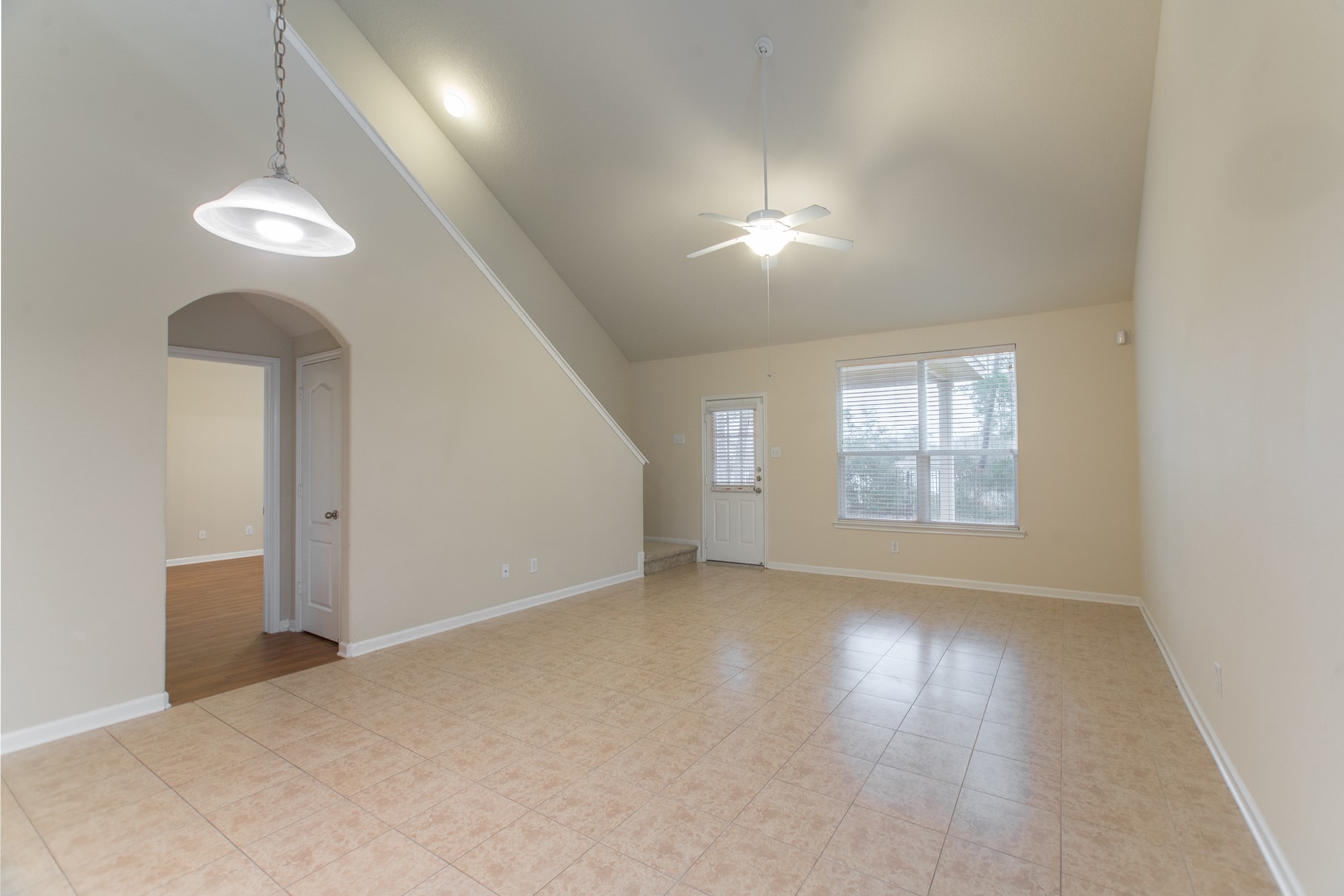78 East Heritage Mill Circle The Woodlands, TX 77375 - Photo 17 of 50 an empty room with wooden floor chandelier and windows