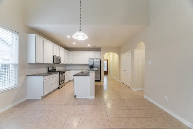 a view of a kitchen with a sink and cabinets