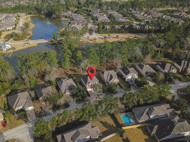 an aerial view of residential house with outdoor space and lake view