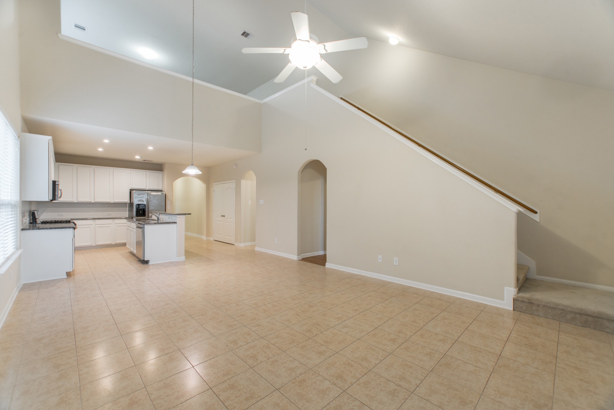 78 East Heritage Mill Circle The Woodlands, TX 77375 - Photo 50 of 50 a view of a livingroom with a ceiling fan and kitchen space