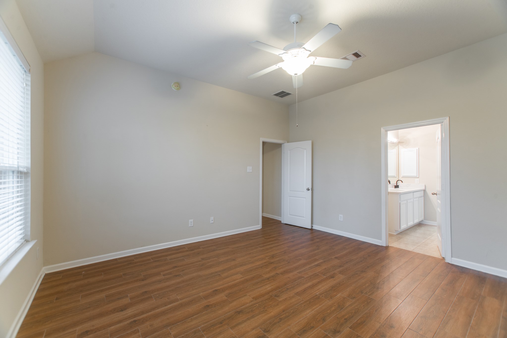 78 East Heritage Mill Circle The Woodlands, TX 77375 - Photo 24 of 50 an empty room with wooden floor and windows