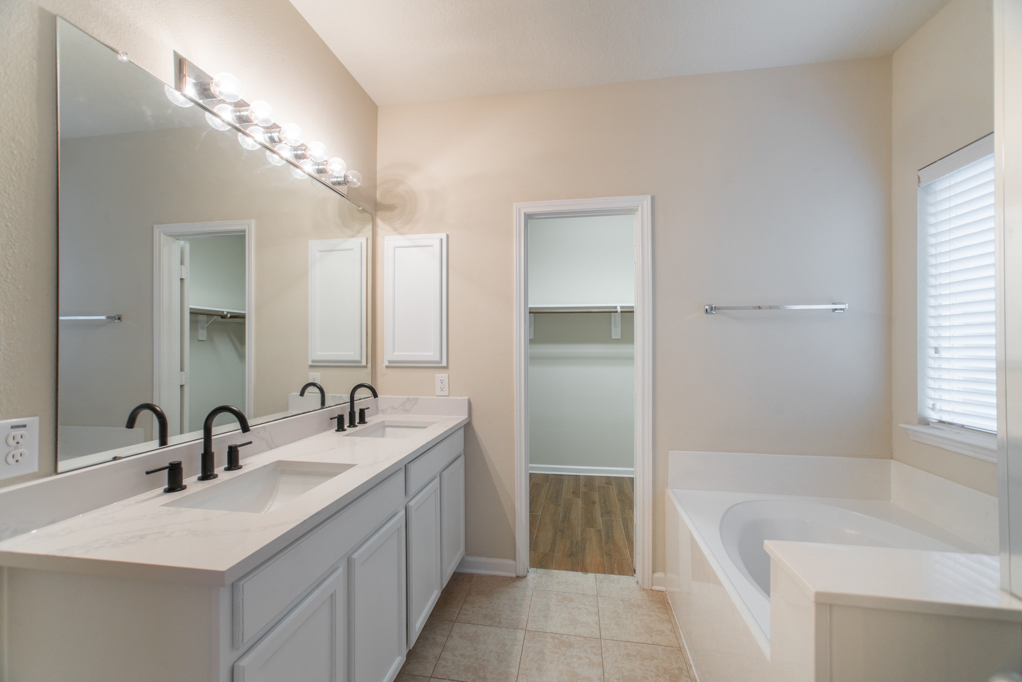 78 East Heritage Mill Circle The Woodlands, TX 77375 - Photo 25 of 50 a bathroom with a tub sink and mirror