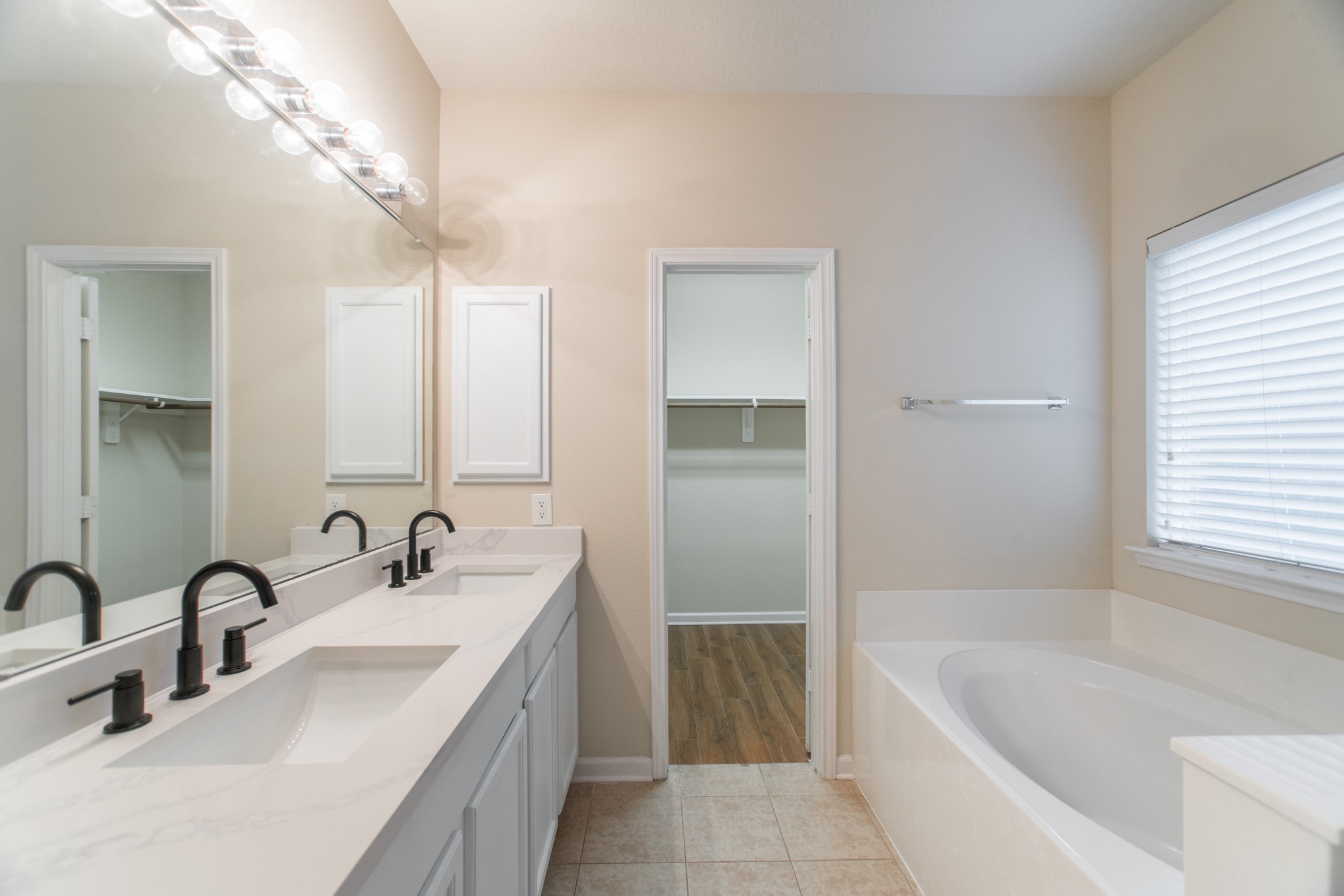 78 East Heritage Mill Circle The Woodlands, TX 77375 - Photo 26 of 50 a bathroom with a tub sink and mirror