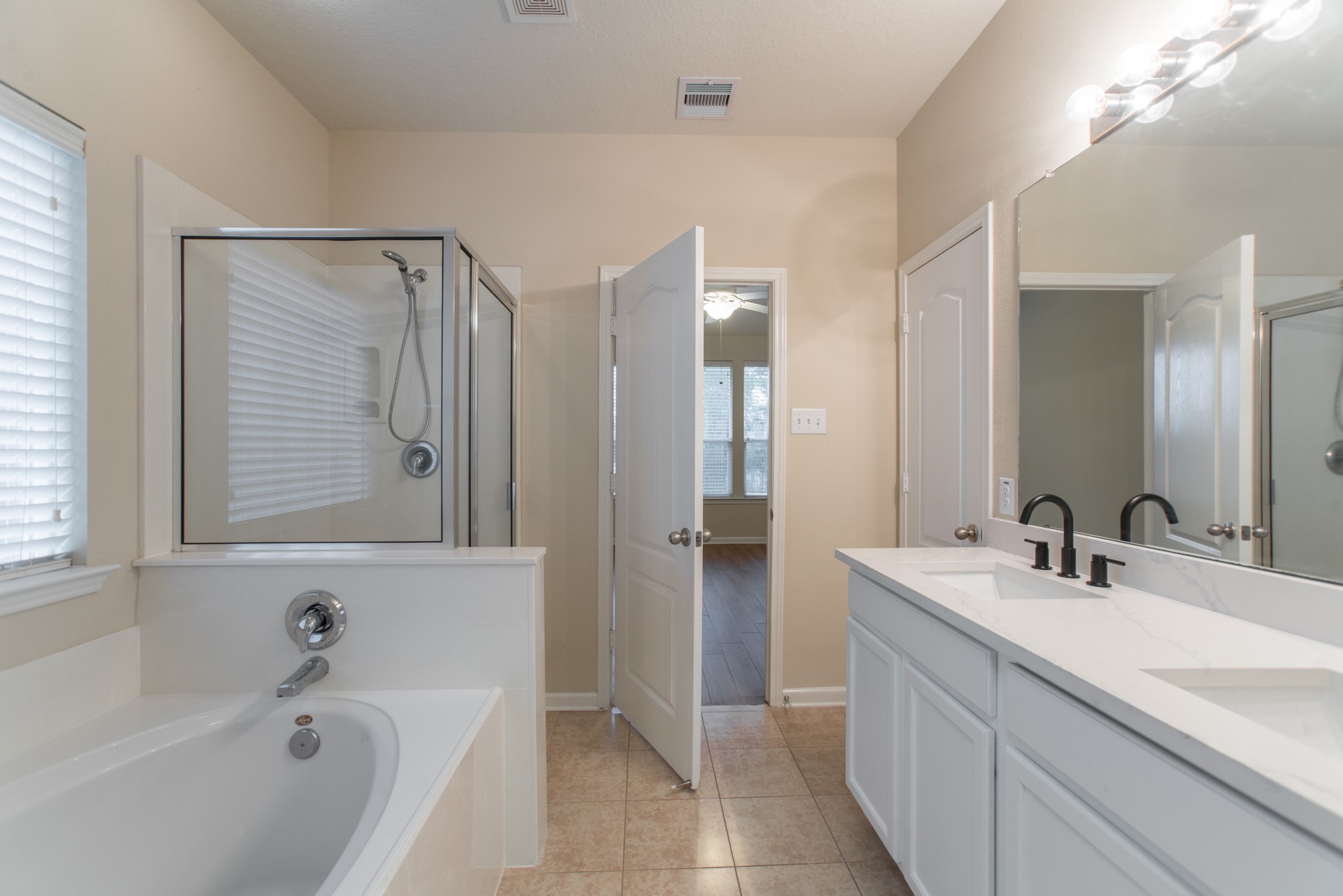 78 East Heritage Mill Circle The Woodlands, TX 77375 - Photo 27 of 50 a bathroom with a tub a sink and mirror