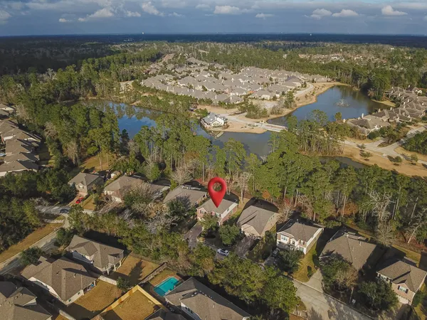 an aerial view of a house with a yard
