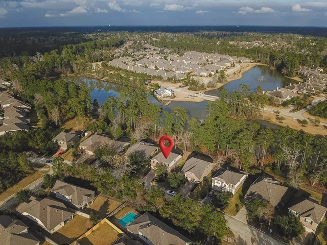 an aerial view of a house with a yard