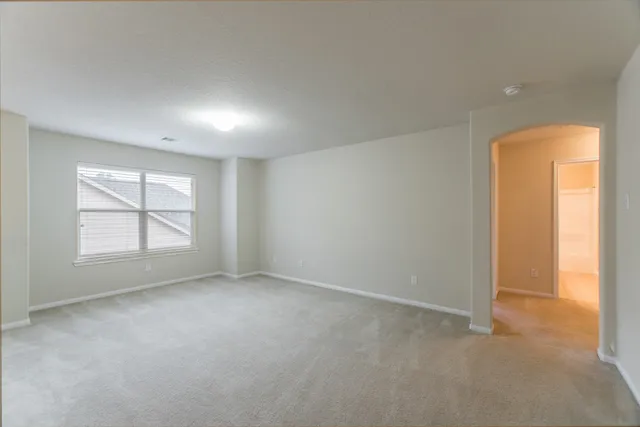 an empty room with a empty space and windows