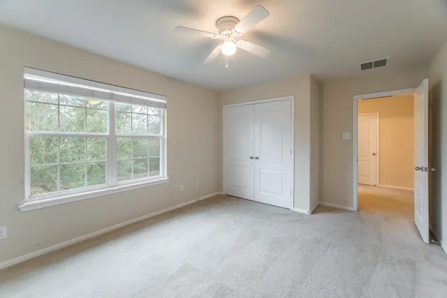 a view of a livingroom with a ceiling fan and window