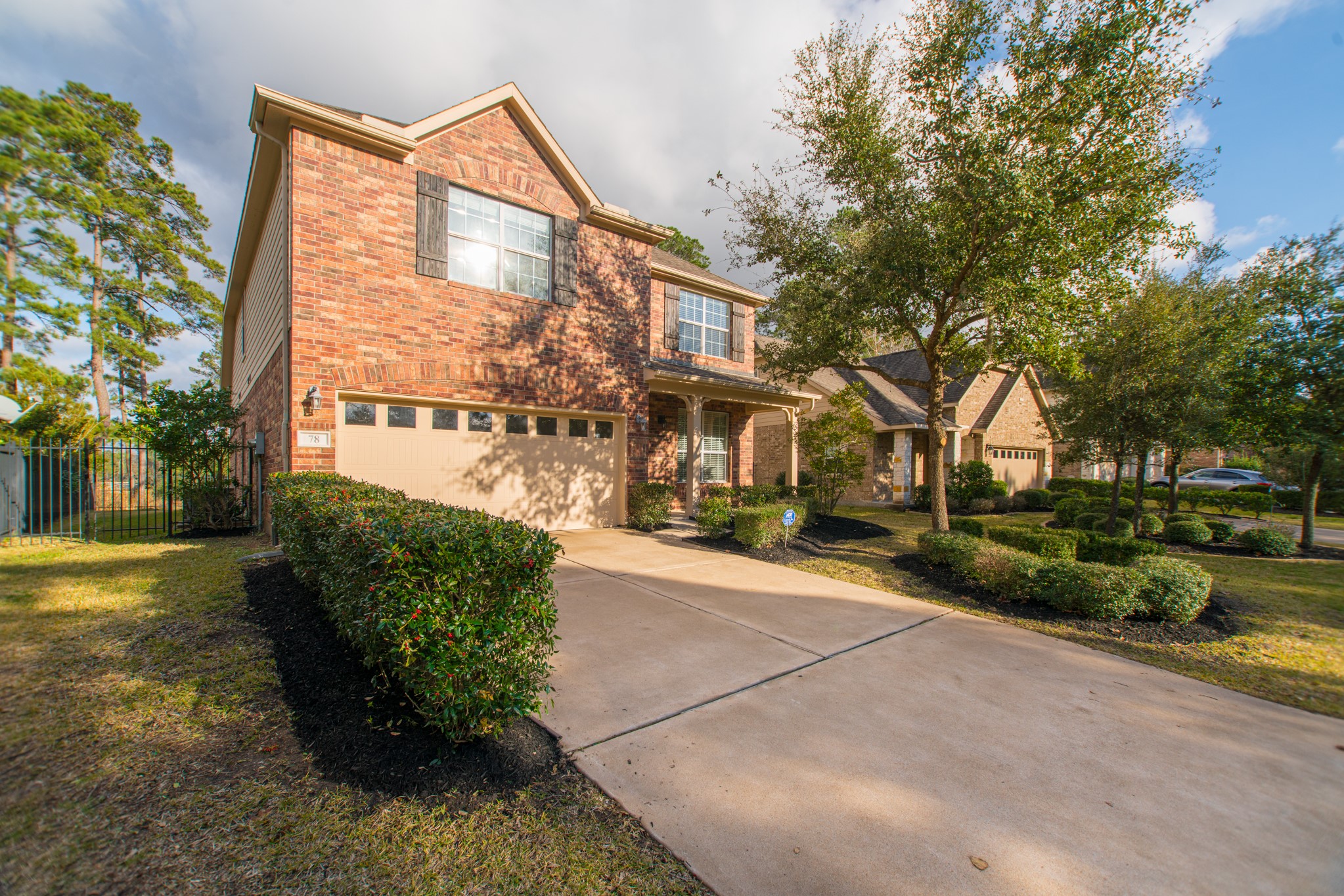 78 East Heritage Mill Circle The Woodlands, TX 77375 - Photo 4 of 50 a front view of a house with a yard and a garage