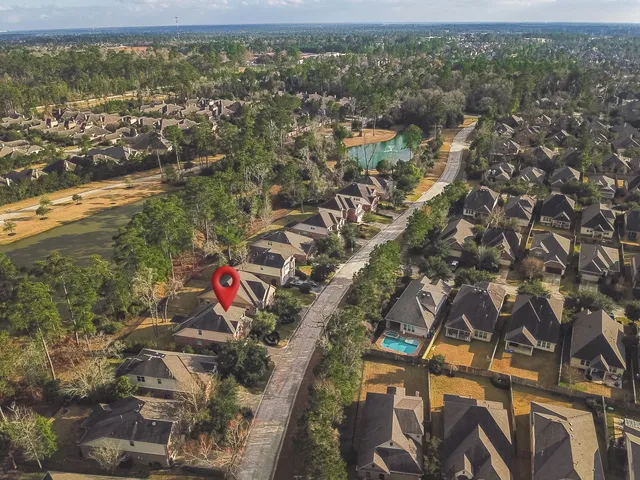an aerial view of residential houses with outdoor space