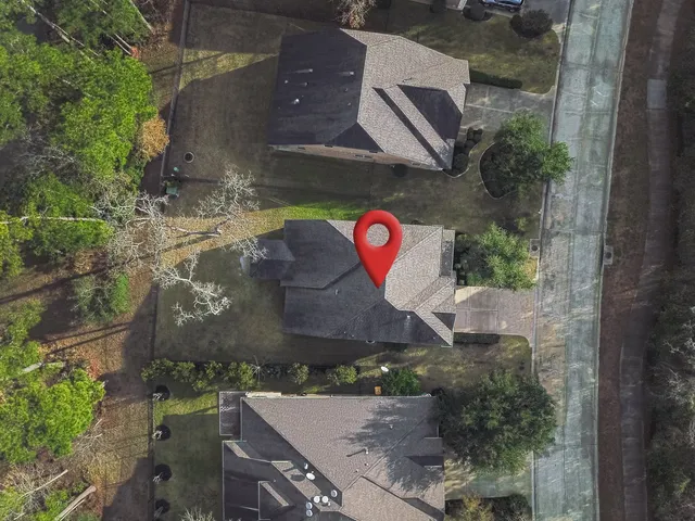 a aerial view of a house with a yard